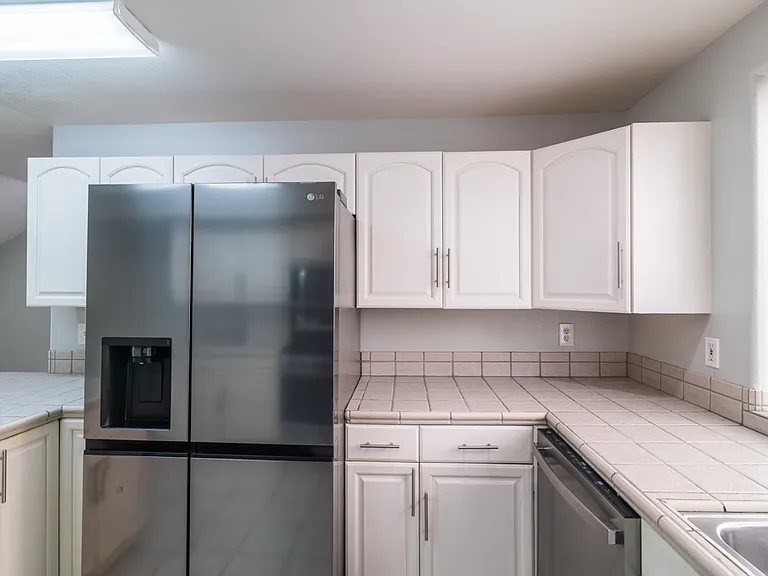 Kitchen with gas stove, full size refrigerator and dishwasher.
