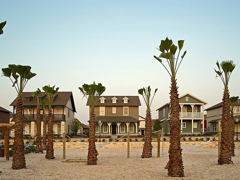 Experience coastal living with these charming homes surrounded by lush palm trees.