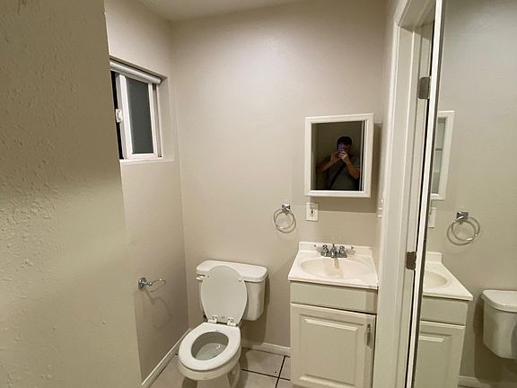 Bath with shower and storage wall unit
