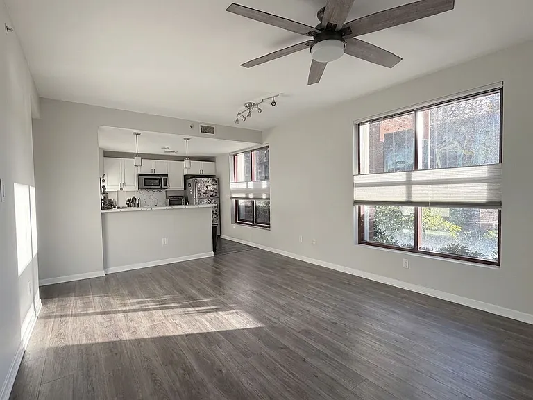 Well lit living room. Versatile custom blinds throughout to choose any type of privacy you'd like.