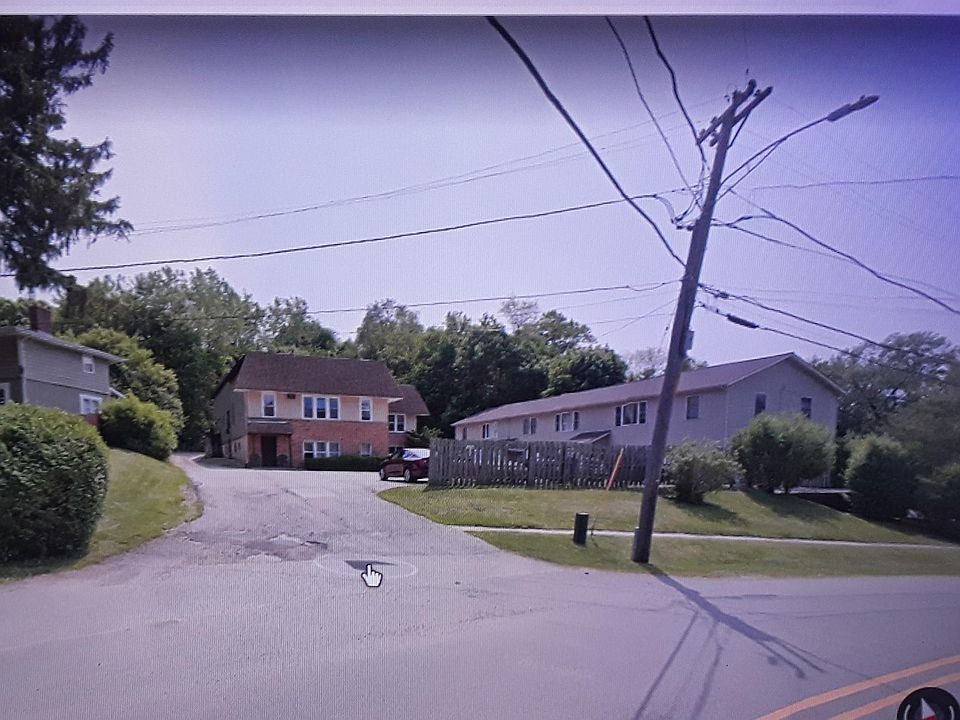 Street view of apartments. The available apartment is on the ground floor of the building on the right.