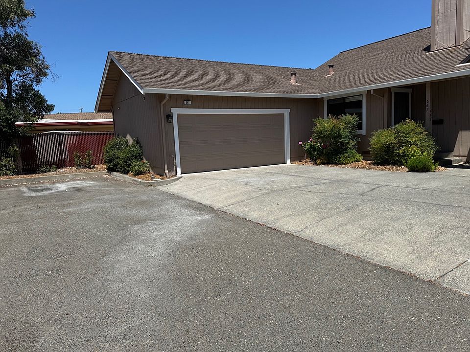 Front of home with view of 2 car garage and parking space to the left...