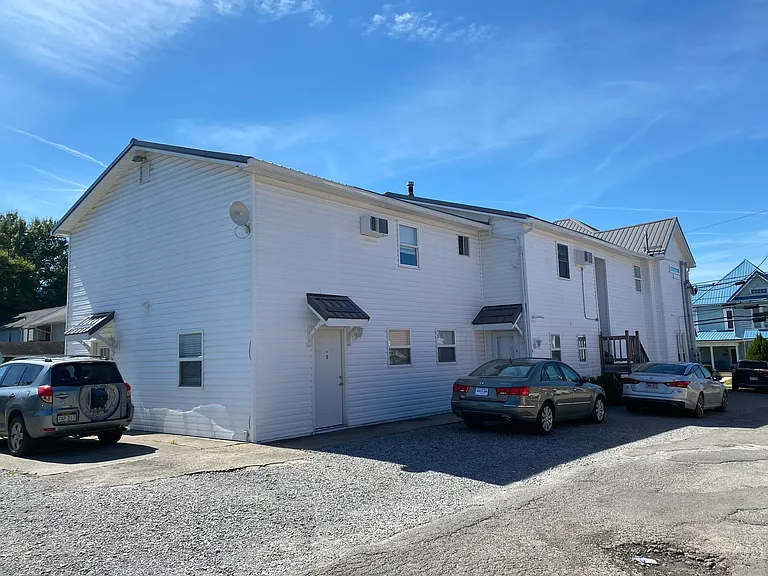 Unit is on the end, ground floor. Two entrances - one on the alley side, one on the parking lot side.