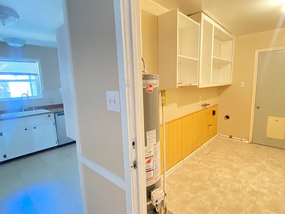 Laundry room off kitchen. Access door to side of house as shown. Also door to garage that is not shown.