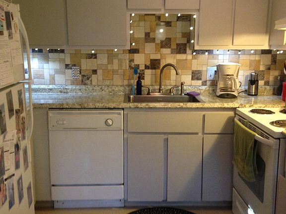 Kitchen with current appliances (they will all be replaced in August) New grey laminate floor has also been installed recently