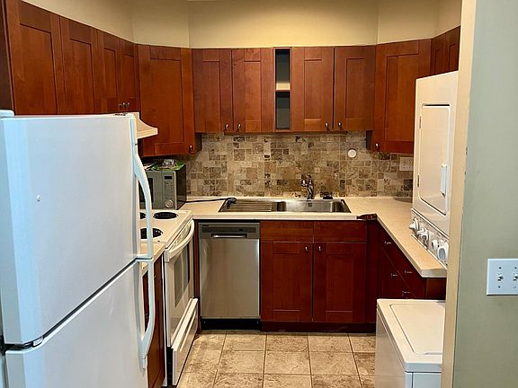 Kitchen with dishwasher and washer/dryer.
