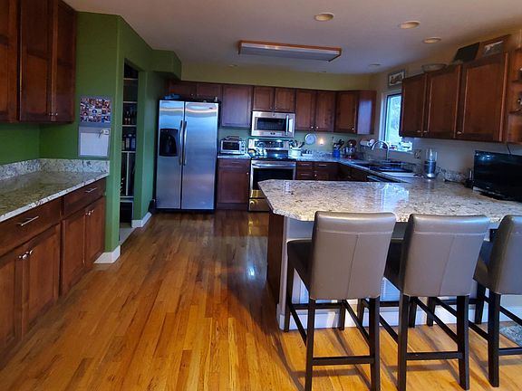 Kitchen with newer stainless steel stove microwave, dishwasher and granite counters