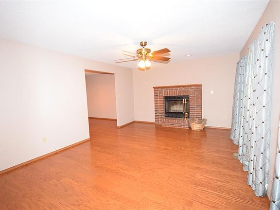 Newer hardwood floor with wood burning fireplace