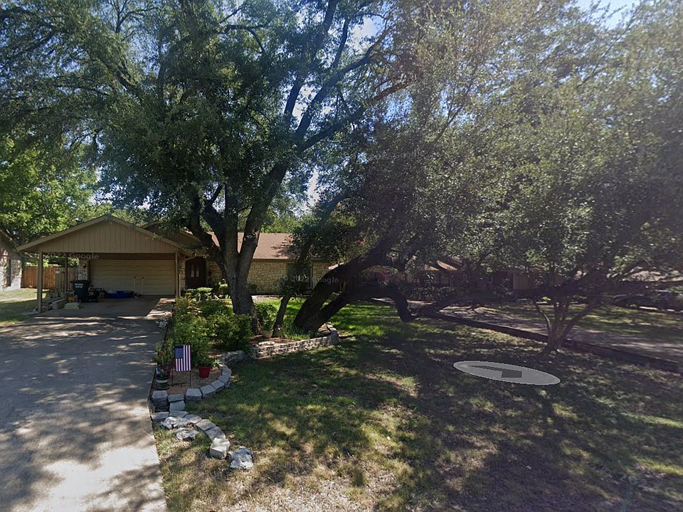 house from street view 
large car port
live oak tree