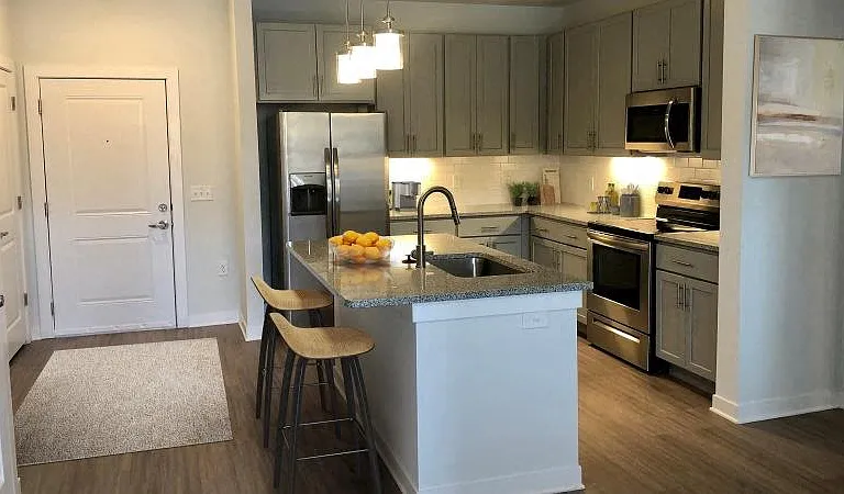 Kitchen with island bar and stainless steel appliances