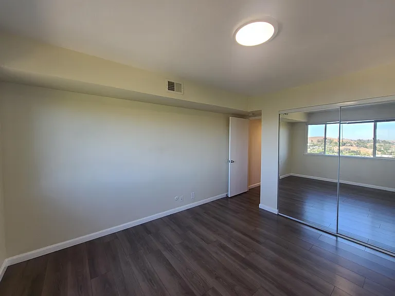 Spacious Closet with Mirrored Sliding Doors