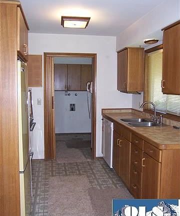 A step saver kitchen with oak cabinets.