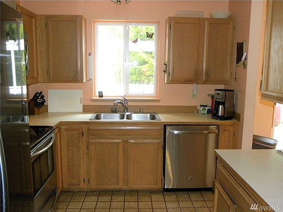 Kitchen with tile floors and newer appliances.