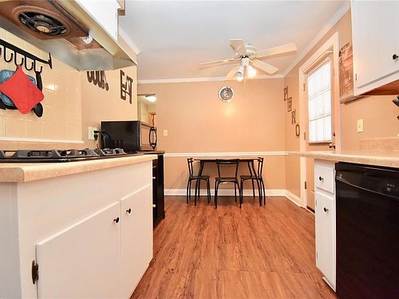 The eat-in kitchen has ample space for dining. Also includes a built-in oven range for a sleek look.