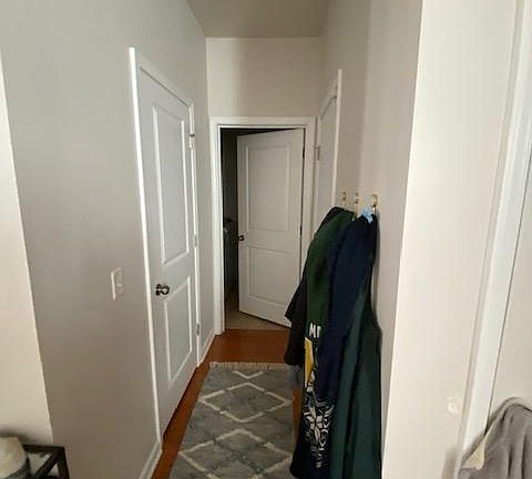 Hallway to 1/2 bath, garage door, and laundry room