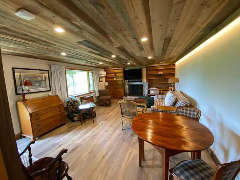 Lower Family Room with wood burning fireplace - sleeper sofa, working desk and separate table