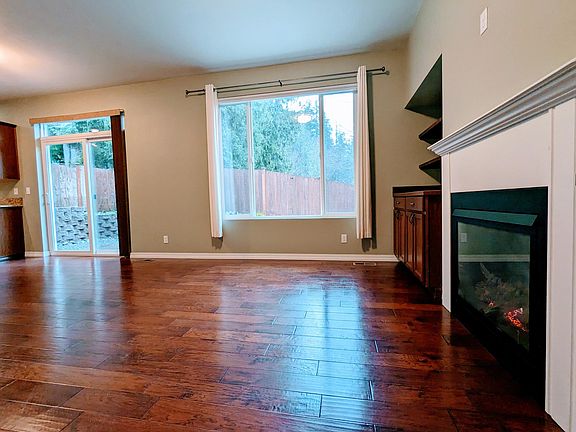 Living room with gas fireplace and backyard access/views