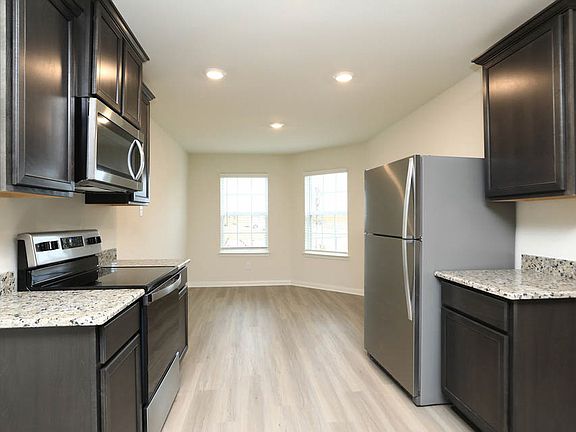 The kitchen opens into a dining area that can be used as a breakfast nook too