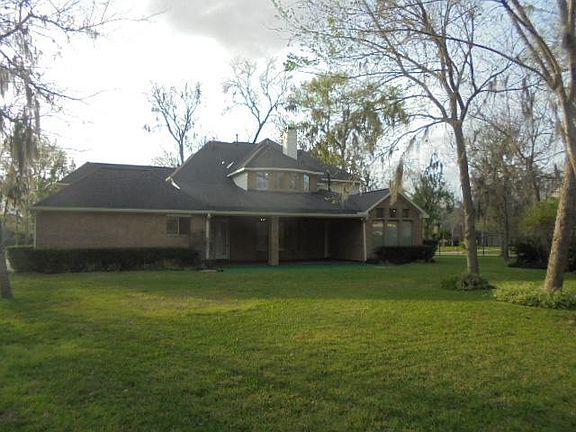 View of the rear of the home and the oversized cov