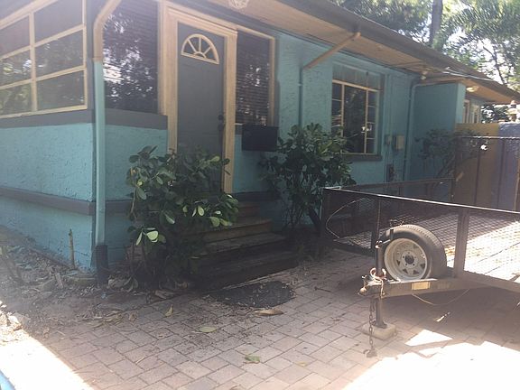 Well maintained home and mature landscaping with large fenced and wood gate entrance Payer driveway