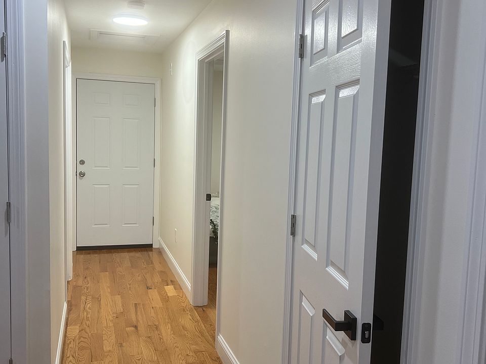 Hall from kitchen towards back door, bedroom #3 and laundry room with hook ups for washer/dryer