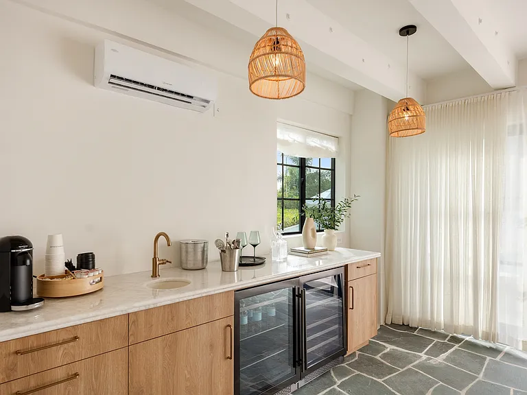 Equipped with dual wine fridges and a coffee station for effortless indulgence.