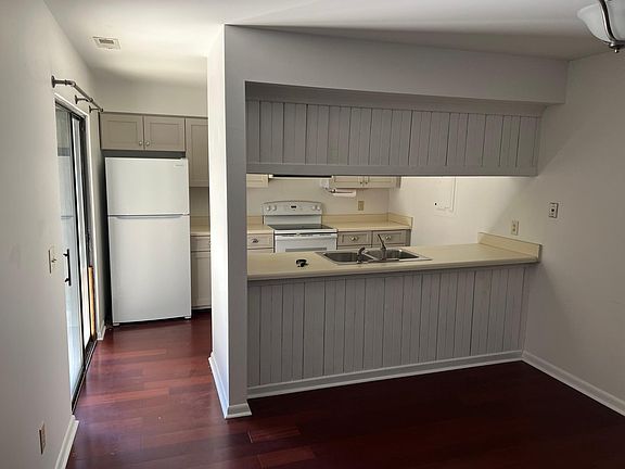 Kitchen area complete with updated dishwasher, stove, and refrigerator.