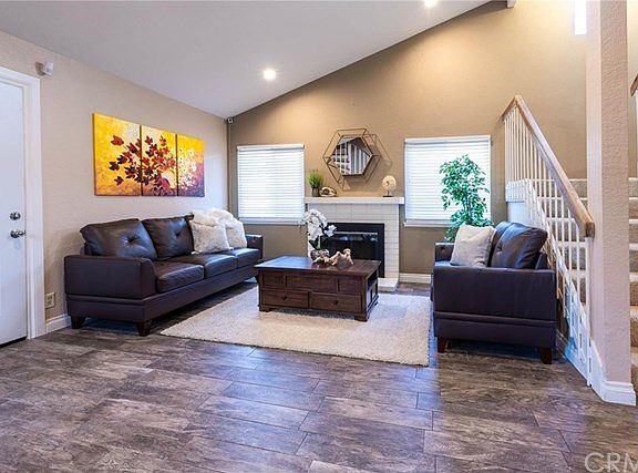 Living room with newer flooring, fireplace and recessed lighting