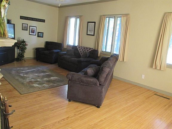 Enjoy this large living room with fireplace and built in shelf.