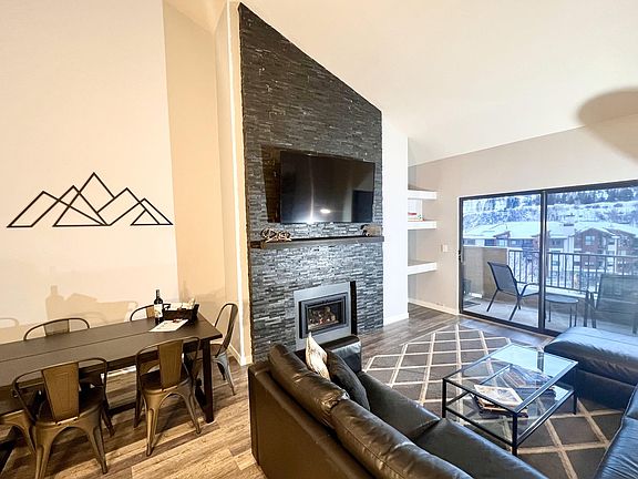 Living room with large sofa-bed sectional and storage chaise lounge, 65 in LED TV, fireplace, balcony with grill and sweeping views of Beaver Creek mountain