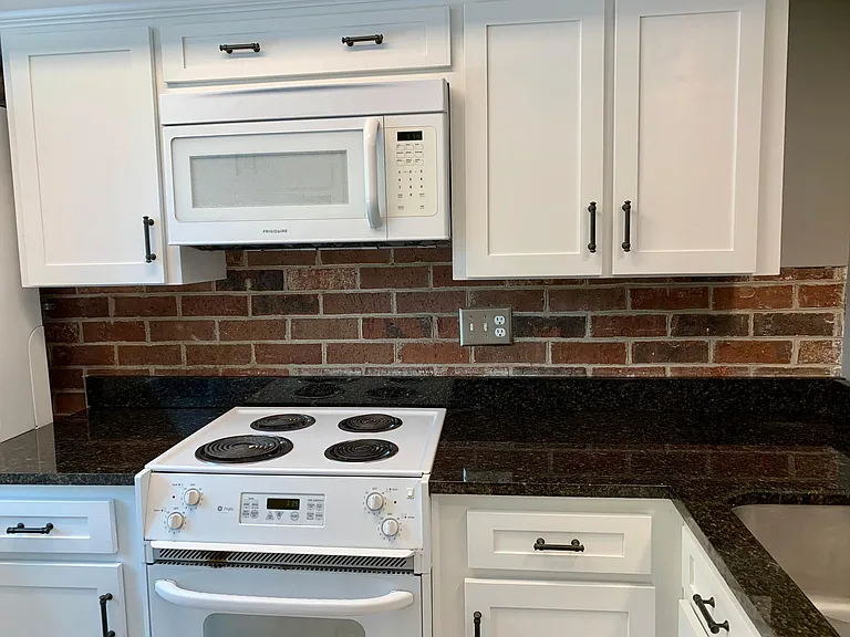Remodeled kitchen with granite countertops, new cabinets, under-mounted sink and new fixtures.