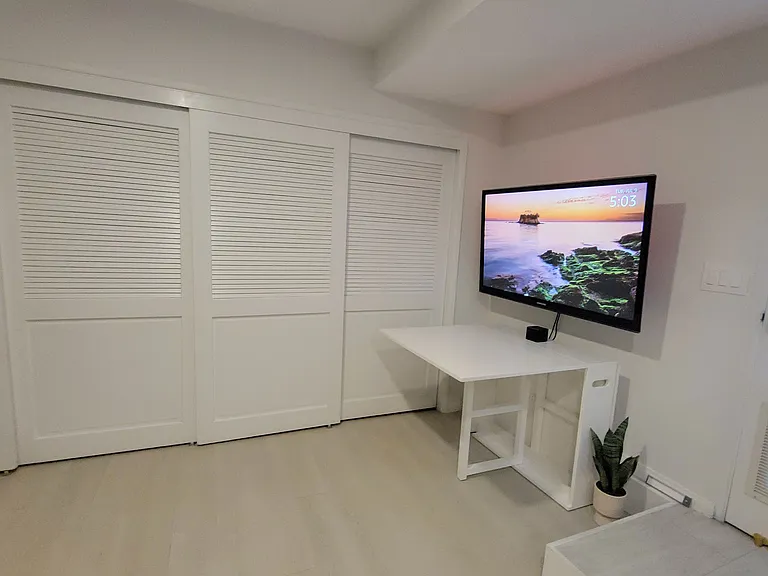 55 inch TV and a convertible desk/table that extends from 8 inches to 67 inches. 4 large closets stocked with a dresser, extra chairs, portable space heater, humidifier and purifier/fan.