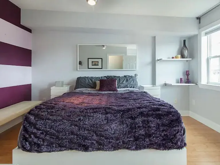 Second bedroom with en suite bath. Wall has been recently painted over, so it is light grey, not purple.