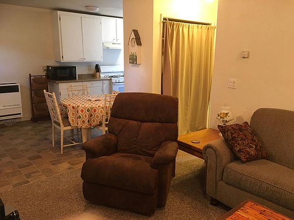 Living room looking back towards a little dining nook, and kitchen.