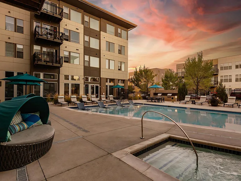 Peaceful Evening Pool Area with Spa and Plush Loungers