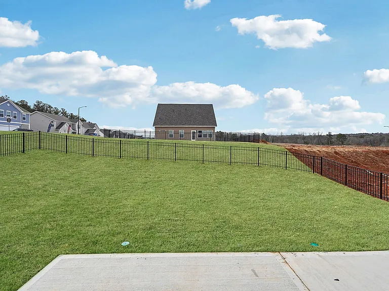 Exterior background of the Alexander floor plan's patio and fenced-in yard.