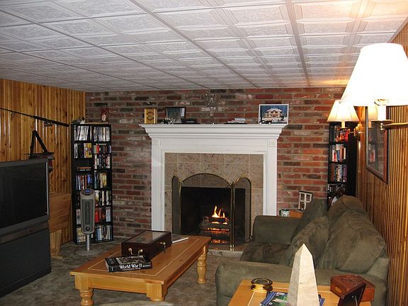 Wood panneled finished basement w/gas fireplace w/granite surround