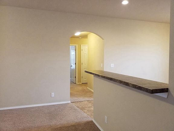 View of hallway to bedrooms and kitchen bar