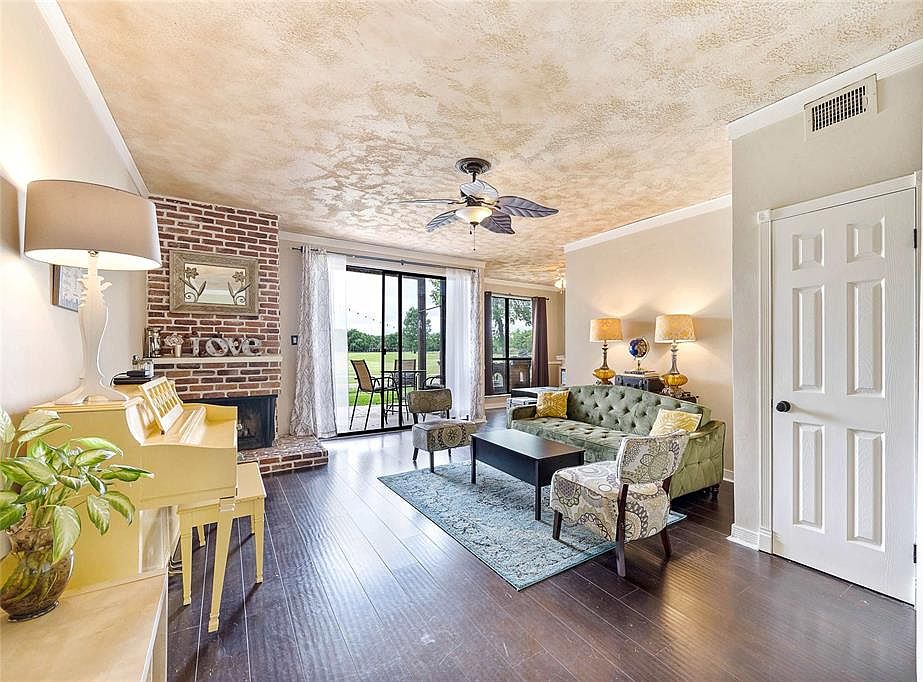 The living room has a brick fireplace and lots of storage. The sliding doors allow lots of natural light into the room.