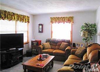 View of the living room that is open to dining and kitchen.