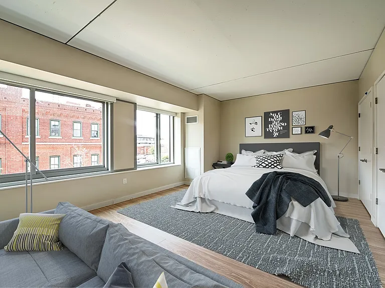 Spacious master bedroom features a walk-in closet and huge windows