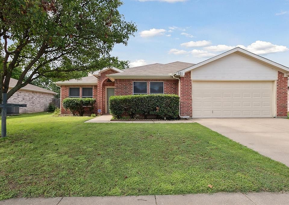 Ranch-style house with a garage, brick siding, concrete driveway, and a front yard