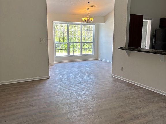 Living room looking into kitchen and dining area