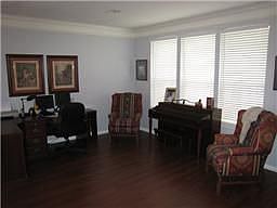 Rich, dark laminate flooring flows through the formal areas.