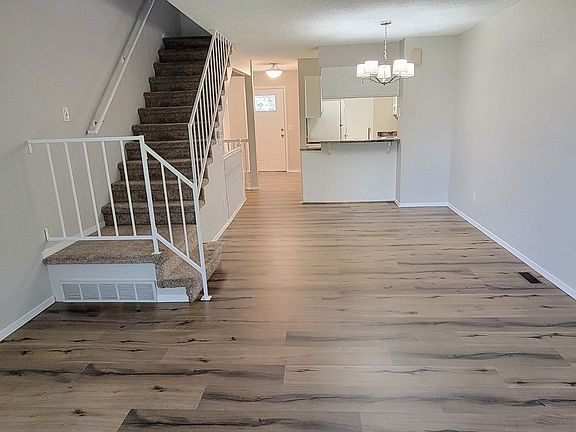 Back side looking to front door, kitchen and stair.