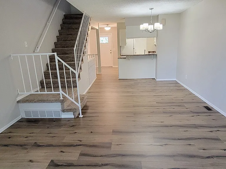 Back side looking to front door, kitchen and stair.