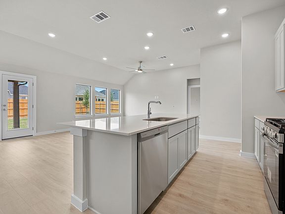 Kitchen in the Brazos home plan by Trophy Signature Homes - REPRESENTATIVE PHOTO