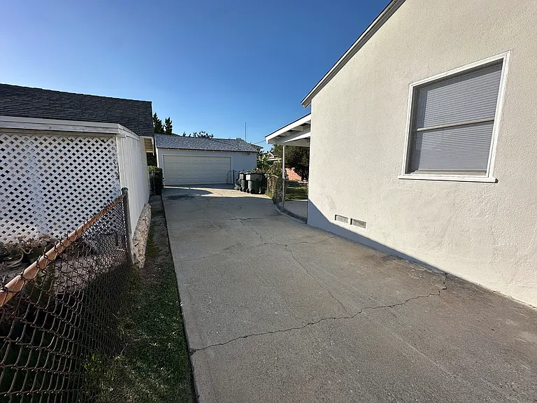 Long driveway with 2 car, detached garage, workbench and storage