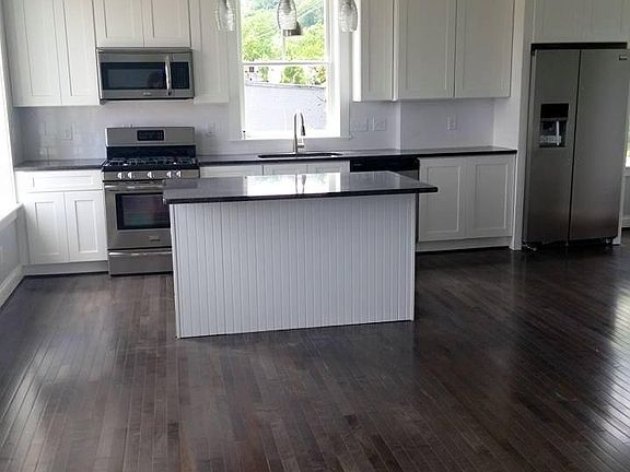 Kitchen with granite counter tops and energy efficient stain