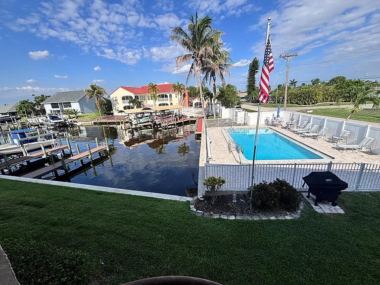 Let's check out the pool....! Enter from the door in your lanai, head down the spiral staircase and explore your backyard where you will find the pool and your own private dock for your boat!